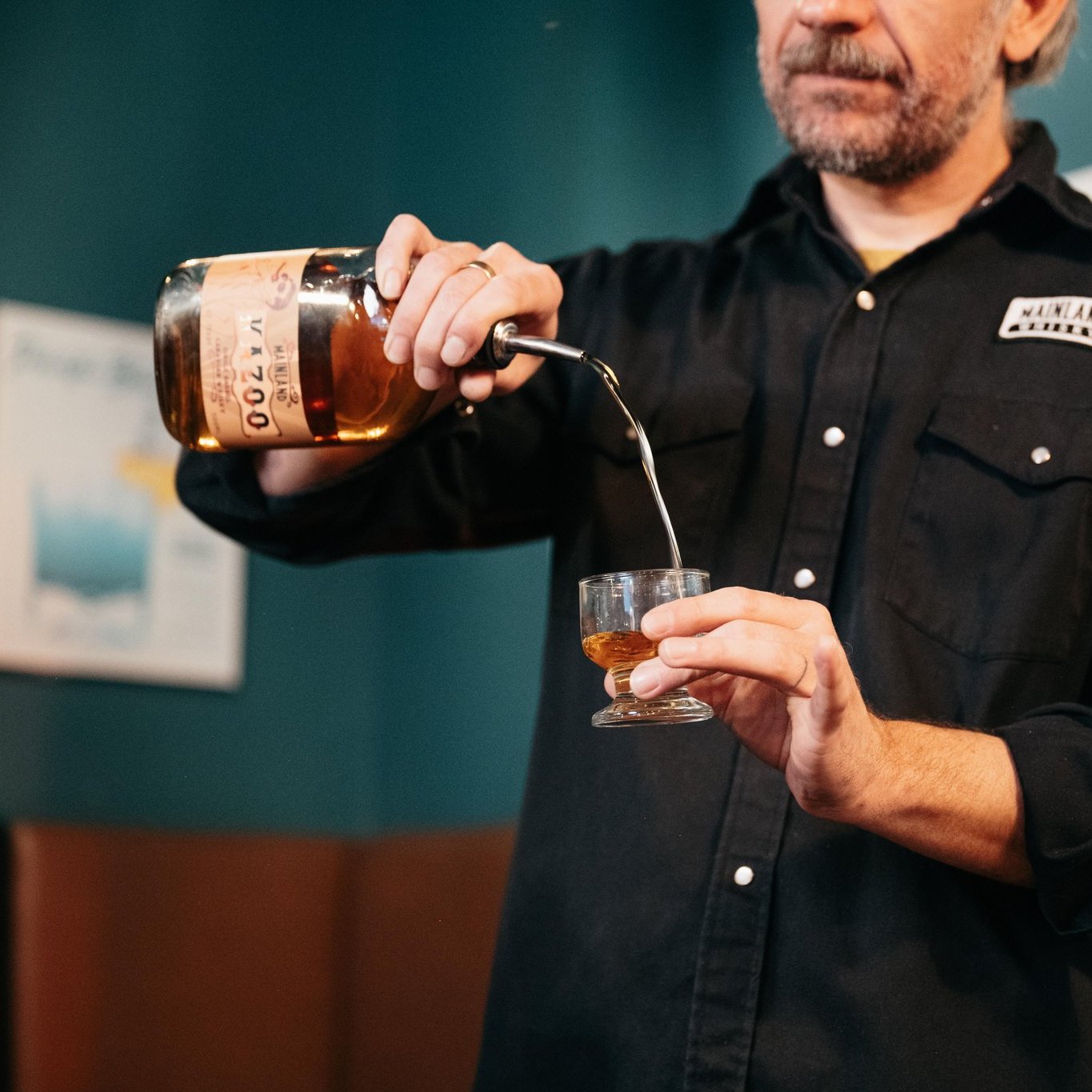 Art of Distilling The Mainland Whisky Story Owner Steve pours a glass of signature whisky